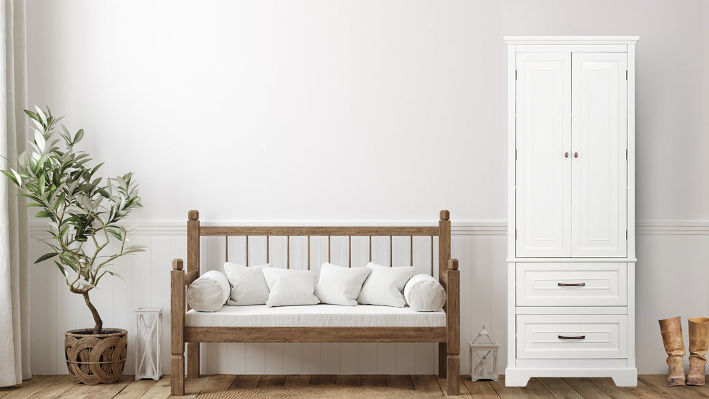 A white storage cabinet next to a coach in a living space